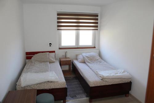 a bedroom with two beds and a window at Odmor u Komaranima in Nova Varoš