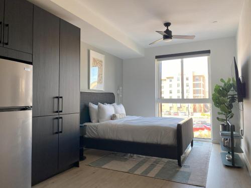 a bedroom with a bed and a large window at Mint House Birmingham - Downtown in Birmingham