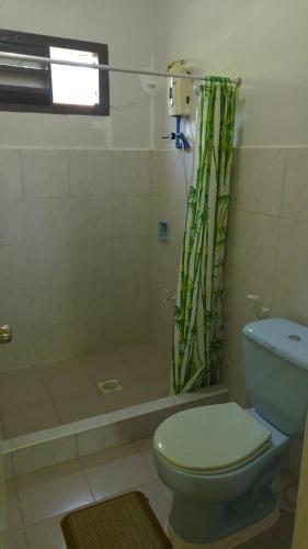 a bathroom with a toilet and a shower at Villa Almedilla Pension House in Panglao Island
