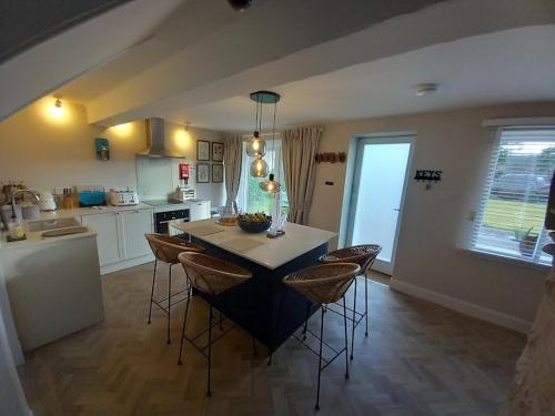a kitchen with a table and chairs in a room at Beautiful Historic Cottage in Callander
