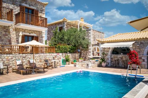 a villa with a swimming pool and a house at LIOKRINA country living villas & suites in Koroni