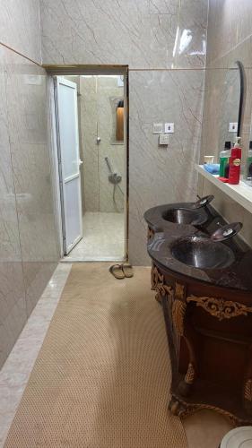 a bathroom with a sink and a shower at شالية الفارس in AlUla