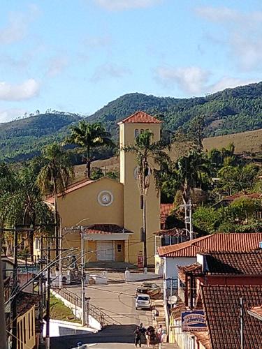 a building with a clock on the side of a street at Pousada Zacarias in Ouro Preto