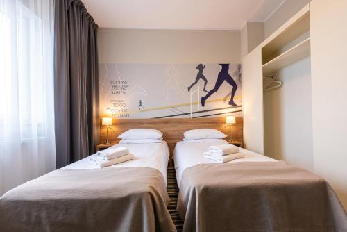 Postel nebo postele na pokoji v ubytování Hotel Maraton