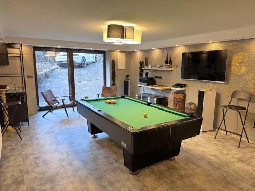 a living room with a pool table in it at Apartments & wellness Kal Koritnica in Bovec