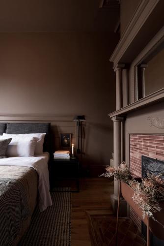 a bedroom with a bed and a fireplace at Dvele Inn in St. John's
