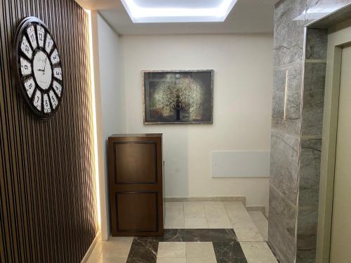 a hallway with a clock on the wall and a door at Karia Plus City Apartments in Kérynia