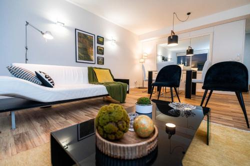 a living room with a couch and a table at Luxus Charming Apt in Angra do Heroísmo