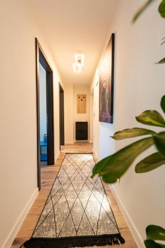a hallway with a door and a plant at Apartman Dior - sauna, self check in in Belišće