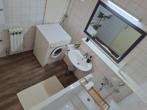 a bathroom with a toilet and a sink and a mirror at Apartman Dory in Zagreb