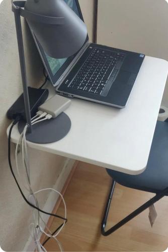 a laptop computer sitting on top of a white desk at Cosey Room in Thornton Heath