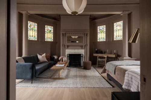 a living room with a couch and a fireplace at Dvele Inn in St. John's