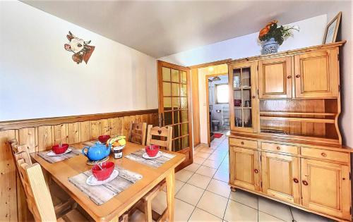 a kitchen with a wooden table and a dining room at Chalet Les Airelles - 2 Pièces pour 4 Personnes 054 in Villarembert