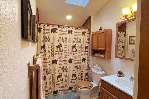 a bathroom with a shower curtain with animals on it at Shady Pines- Cozy Mountain Retreat in Idaho Springs