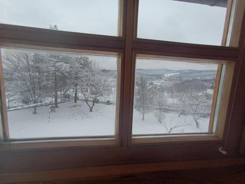 a window with a view of a snow covered field at Villa Ema in Sarajevo