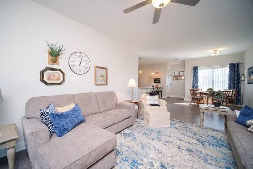 a living room with a couch and a ceiling fan at Main Floor Cozy 2 Bedroom Condo in Bettendorf in Bettendorf