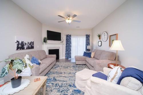 a living room with two couches and a fireplace at Main Floor Cozy 2 Bedroom Condo in Bettendorf in Bettendorf