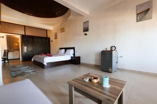a bedroom with a bed and a coffee table at Sunshine Divers Club in Sharm El Sheikh