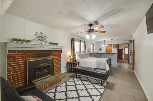 a living room with a bed and a fireplace at Silver Creek Getaway with Fireplace - 12 Mi to Lake in Prentiss