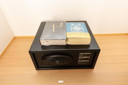 a microwave with three books on top of it at Light Hotel - Vacation STAY 91012v in Tokyo