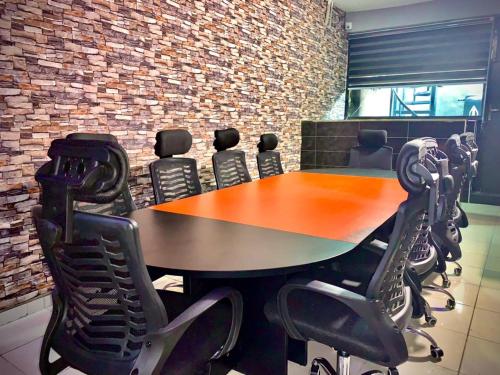 a conference room with a wooden table and chairs at Vintage Classic Hotel in Lagos