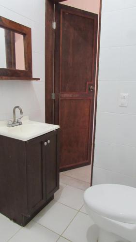 a bathroom with a sink and a toilet at Hab #4 La Casa Del Profe Salo in Santa María Tonameca