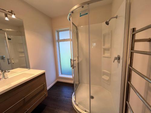 a bathroom with a shower and a sink at Large and Luxurious at the Lake in Kinloch