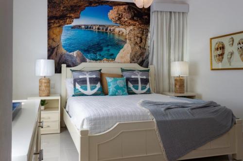 a bedroom with a bed with a cave wall at Dream villa with pool & garden view in Vista Cana in Punta Cana