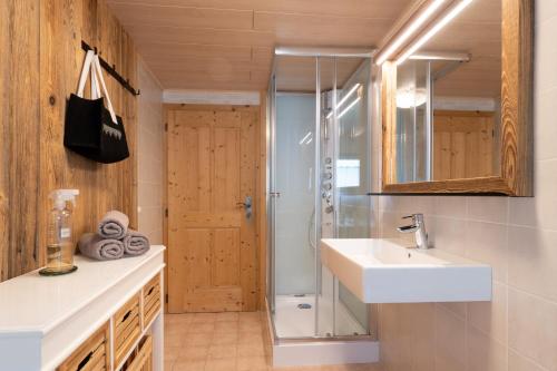 a bathroom with a sink and a shower at Chalet Kasern in Gais