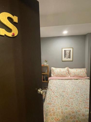 a bedroom with a bed and a letter s on the wall at Exclusivas Habitaciones al Oriente in Mexico City