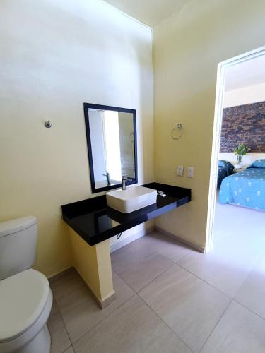 a bathroom with a sink and a toilet at VILLAS DULCE SUEÑOS RESIDENCIAL in Rincon de Guayabitos