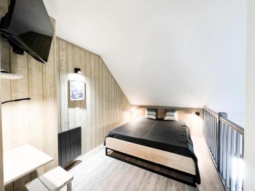 a bedroom with a bed in the middle of a staircase at Chalets Du Galibier I - Studio pour 4 Personnes 654 in Valloire