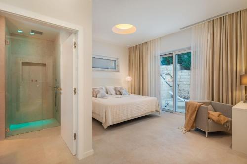 a bedroom with a bed and a sliding glass door at Villa More in Selca