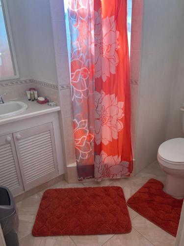 uma casa de banho com um WC e uma cortina de chuveiro em StayHaven Escapes em Saint Michael