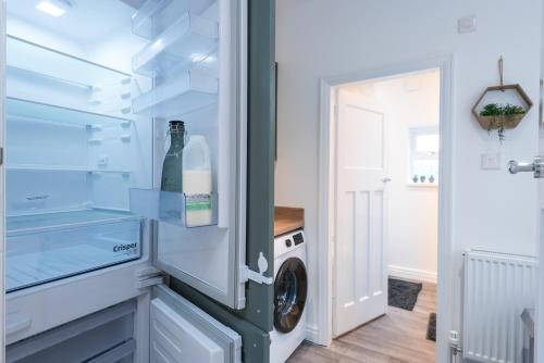 a refrigerator with a bottle of wine in it at Rio's Retreat in Cottingham