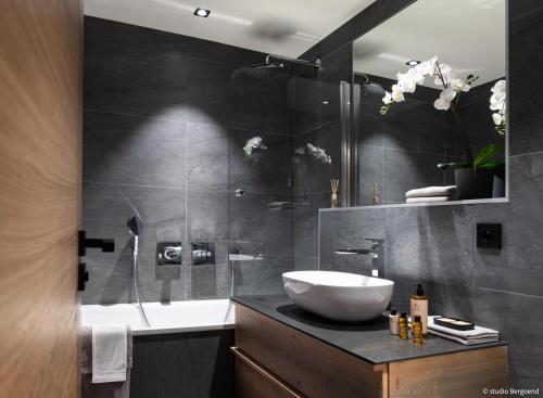 a bathroom with a sink and a glass shower at Résidence Arc - Chalets 114 in Arc 1800