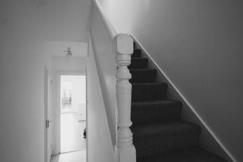 a stairway with a stair railing and a stair case at Milton Place in London