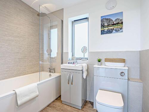 uma casa de banho com um WC, um lavatório e uma banheira em 2 Bed in East Bergholt 82399 em East Bergholt
