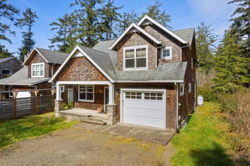 a house with a white garage at Sandpiper House-Manzanita Or in Manzanita