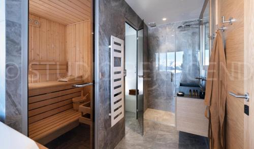 a bathroom with a shower and a glass door at Résidence Eden - Chalets pour 14 Personnes 124 in Arc 1800