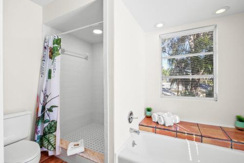 a bathroom with a shower and a toilet at The River House in Bradenton