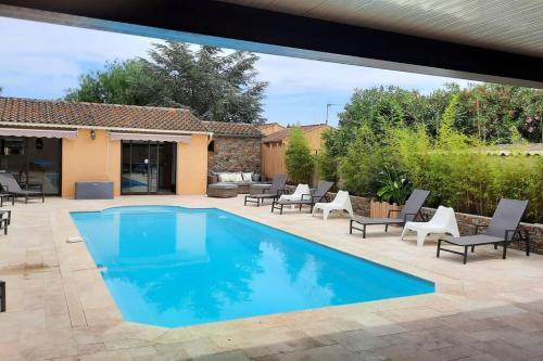 - une piscine dans une cour avec des chaises et une terrasse dans l'établissement Les clés de Bormes 40 m2, à Bormes-les-Mimosas