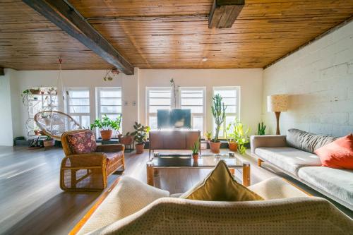 a living room with a couch and a table at Le Loft Audrey in Quebec City