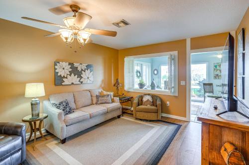 a living room with a couch and a ceiling fan at Auburndale Vacation Rental with Yard and Lake Views in Auburndale