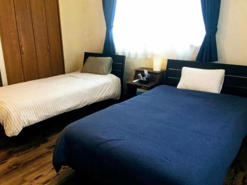 Yoron Tandy-House - Vacation STAY 78648v tesisinde bir odada yatak veya yataklar