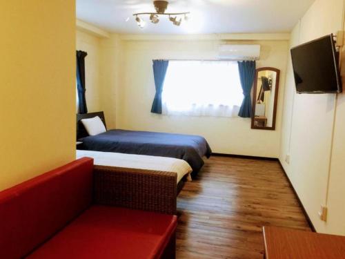 a hotel room with two beds and a window at Yoron Tandy-House - Vacation STAY 78648v in Yoron