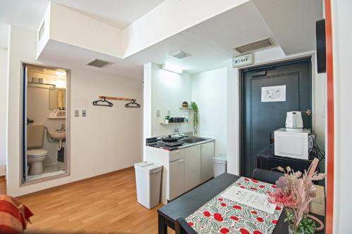 a small kitchen with a table in a room at Tenmabashi Home in Osaka - Vacation STAY 16207 in Osaka
