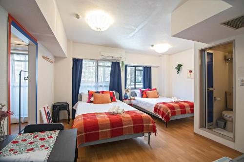 a hotel room with two beds and a table at Tenmabashi Home in Osaka - Vacation STAY 16207 in Osaka