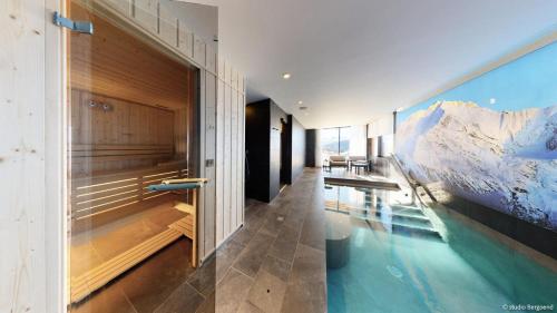 a swimming pool with a mountain mural on the wall at Résidence Arpoza - Chalets pour 15 Personnes 094 in Arc 1800