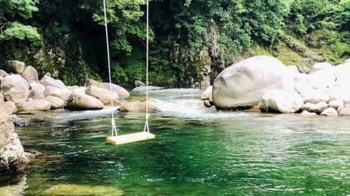 a swing in the middle of a river at Riverside Glamping Nuts - Vacation STAY 84737v in Komono